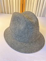 Left front view of gray herringbone wool fedora hat