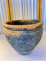 Full view of planter exterior showing floral relief and color