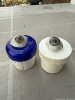 Both glass eyes on their respective plastic bases