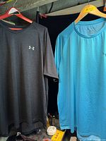 Both Under Armour t-shirts hanging side by side