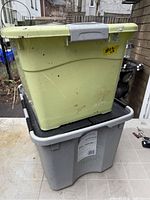 Stacked view of both totes showing colors, lids and overall wear