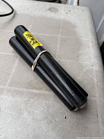 Three black wooden legs bundled together