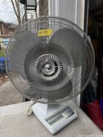 Front view showing full fan with grille and base