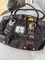 Front view showing fabric, faux leather trim, hardware, handles