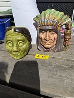 Both ceramic Native American face mugs on table