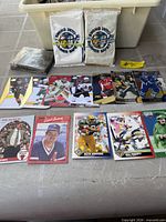 Overall lot view showing sealed promo packs, loose cards laid out, and wrapped bundle