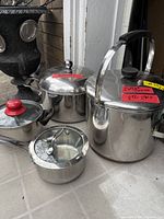Group shot of all four pots and three lids