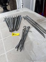 Overview of all tent pegs: stack of flat stakes, separate wire stakes