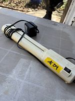 Full view of Fellowes ShredStik with power adapter wrapped around unit