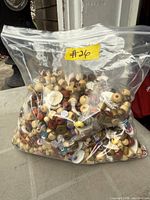 Large clear zipper bag containing mixed wooden and plastic beads