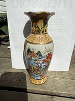 Full view of vase showing shape, painted scenes and gilt detailing