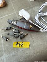 Beautural nail drill handset, six attachments and power adapter laid out