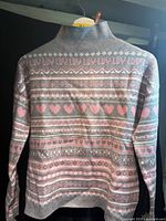 Back view of grey sweater with pink/white fair-isle heart and text pattern