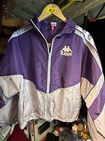 Front view of Kappa windbreaker jacket on hanger