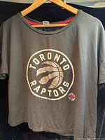Full front view of Toronto Raptors women’s shirt on hanger