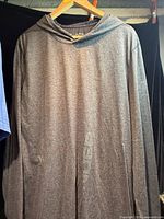 Full front view of grey heather Under Armour hoodie on hanger