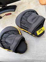 Top view of pair of boxing mitts showing mesh hand pockets and wear