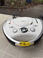 Front and top view showing controls, CD lid, display, speaker grills