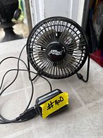 Front angled view of Cool Works desk fan with USB cable visible