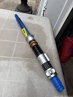 Full view of extendable blue Lightsaber Forge Obi-Wan Kenobi toy lightsaber on table