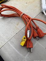 Orange extension cord showing plug ends
