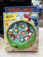 Front view of boxed vintage battery powered fishing game showing game board and fish pieces