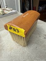 Angled view of full brush showing wood handle and horsehair bristles