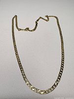Full view of gold-tone curb link necklace