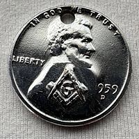 Obverse of 1959-D silver-toned Lincoln cent showing Masonic stamp and drilled hole