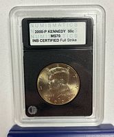 Front of INB slab showing obverse of coin and label