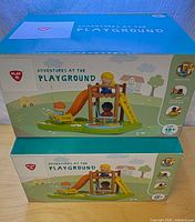 Front view of two stacked PlayGo Adventures at the Playground boxes