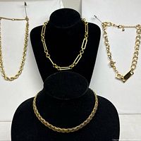 Group shot showing all four gold-tone necklaces