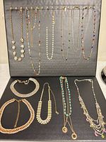 All ten necklaces displayed on board showing variety and condition