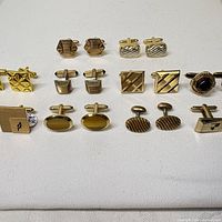 Front view of all eight pairs of cufflinks showing designs and stone accents