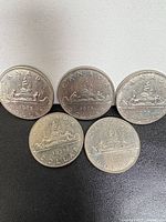 Five 1975 Canadian Voyageur dollars grouped
