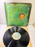 Front snakeskin cover with coin emblem and record