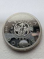 Reverse of 1964 Canada silver commemorative dollar showing legends and design