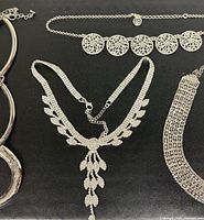 Overview of four silver-tone necklaces and chokers