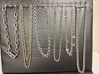 Full view of all six necklaces hanging on display board