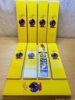 Front view showing six closed yellow promo boxes and three opened to display interiors
