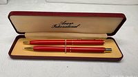Set opened showing pen, pencil, and interior branding