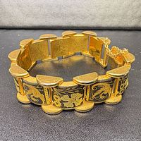Oblique view of bracelet showing panel faces, clasp and safety chain