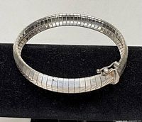 Sterling silver omega bracelet clasp side on display stand