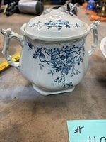 front view of lidded sugar bowl showing floral transfer decoration and twin handles