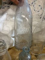 Close-up of embossed J.F. Stratton clear bottle