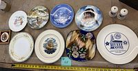 All items laid out showing eight plates, salt & pepper shakers, framed medallion