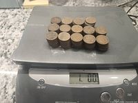 20-coin stack on scale reading 1.00 oz
