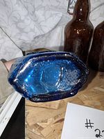 Base of cobalt blue bottle showing color and glass thickness