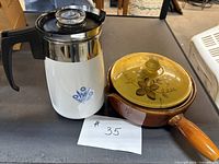 Coffee carafe and stoneware saucepan side by side