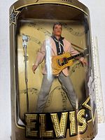Front of boxed Elvis Presley Teen Idol doll showing figure, guitar, microphone stand and box graphics
